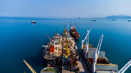 Large container port with cargo ships and gantry cranes