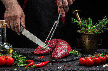 Canvas Print - Fresh and raw beef meat. Whole piece of tenderloin with steaks and spices ready to cook on dark background, banner, menu, recipe place for text, top view