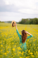 Beautiful woman in the blooming field. Nature, vacation, relax and lifestyle. Summer landscape.