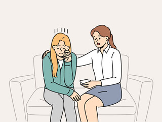 Crying woman at reception of psychologist consoling patient sitting on couch and experiencing stress. Girl sobs in psychologist office after being fired or having problems in personal life