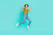 © deagreez - Full length photo of overjoyed energetic person jumping raise fists isolated on teal color background