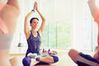 Focused woman with arms raised in exercise class