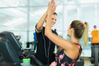 © KOTO - Smiling women high fiving at gym