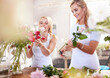 Smiling florists arranging bouquet in flower shop