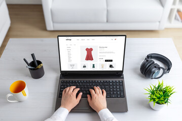 Wall Mural - stylish woman exploring the clothes online, shopping, selecting a beautiful red dress that perfectly
