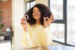 pretty afro black woman feeling happy, showing approval with okay gesture. dental retainer concept