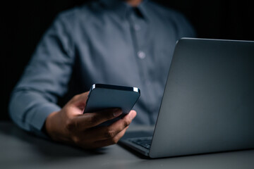 A man hand using mobile phone is paying money for home loan payment.