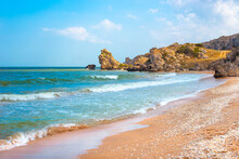 Seascape. Blue Sea And Rocky Shore With Yellow Sandy Beach. Sea Of Azov In Crimea
