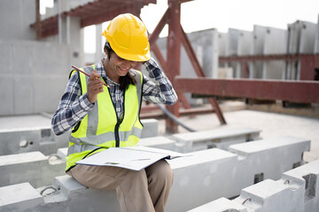 Wall Mural - India engineer woman working with document at precast site work	