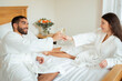 © Prostock-studio - Newlywed Couple Clinking Glasses Enjoying Sparkling Wine In Hotel Bedroom