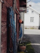 Vertical Of Fishing Nets Hanging From A Wooden House Wall From Outside