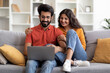 © Prostock-studio - Portrait Of Romantic Indian Spouses Relaxing With Laptop At Home