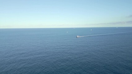 Sticker - Aerial video of the white boat on the crystal clear sea and the shore, Malta