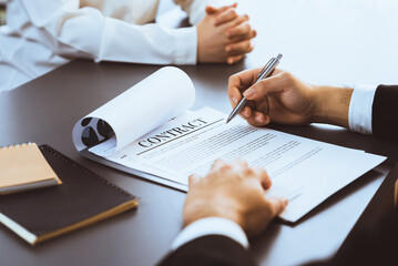 Canvas Print - Closeup businessman sign contract or legal document with pen in his hand during corporate meeting for business deal or legal executive decision to pay off a loan or filing for bankruptcy. Equilibrium