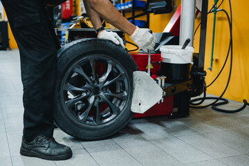 Close-up of a mechanic holding a tire changing device To change new tires.