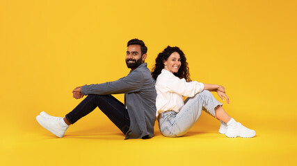 Wall Mural - Romantic Middle Eastern Couple Sitting Posing Together On Yellow Background