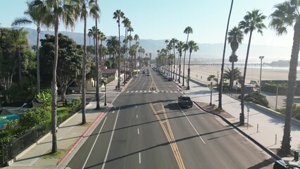 Sticker - Drone view of a highway across the beach in Santa Barbara, California with palm trees and traffic