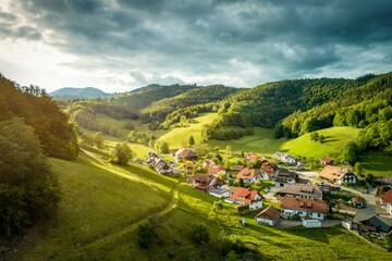 Canvas Print - Beautiful view of a village surrounded by green hills. Black Forest, Germany.