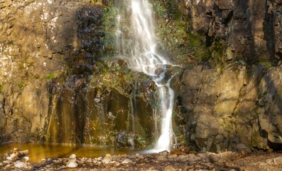 Poster - Large splashing cascading waterfall in the mountains