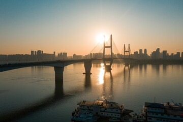 Canvas Print - Sunset scene of a bridge over the River Severn with silhouette modern buildings