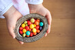 Colorful candies in silver bowl on the little girl hands. Traditional ramadan and sacrifice holiday in Turkey. Turkish culture concept.