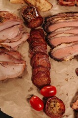 Poster - Vertical of different types of sliced meat and barbecue put on the table