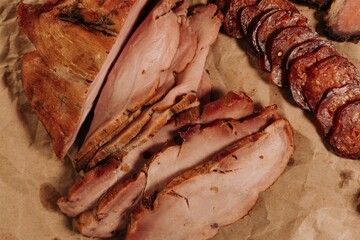 Sticker - Closeup of sliced ham and sausage on a table