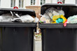 View of garbage containers with trash in city, closeup