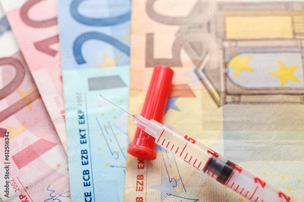 Syringe with insulin on euro banknotes, closeup. Expensive medicine concept