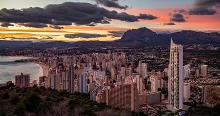 Poster - Scenic view of the coastline town Benidorm under cloudy pinky sunset sky, Spain