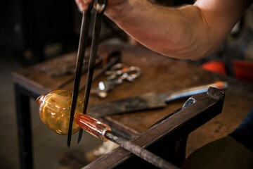 Poster - Glass blower making yellow glass mold with high heat fire for shaping