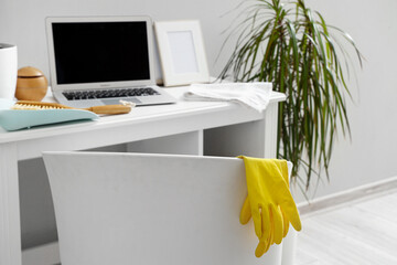 Chair with rubber gloves in office, closeup