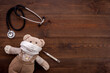 Kids medical checkup and health concept with stethoscope and teddy bear
