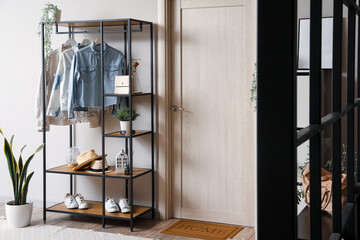 Wall Mural - Shelving unit with clothes and accessories in interior of modern hall