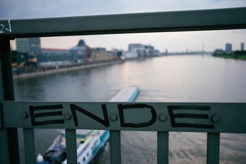 Wall Mural - the word ende is written on the railing. in the background is a ship on the river.