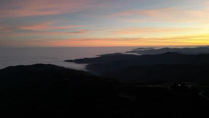 Sticker - 4K landscape Drone Video Flying Over Clouds in the Mountains at sunset