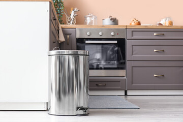 Poster - Metallic trash bin on floor in modern kitchen