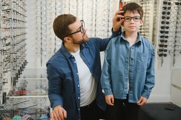 Wall Mural - Father with cute son. Family buy glasses