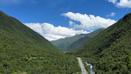 Poster - Valley with green hills under the cloudy sky