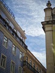 Canvas Print - Vertical shot of the blue buildings with a cloudy sky in the background, Lisbon, Portugal