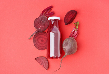 Wall Mural - Bottle of healthy beet juice on red background