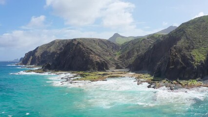 Canvas Print - Landscape scene of splash sea waves under green cliffs range in Maderia island, Portugal