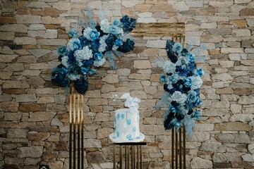 Closeup shot of a blue cake near the brown wall