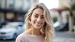 © Adriana - Headshot of a beautiful blond smiling young woman looking at the camera in a city street. Generative AI