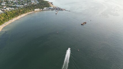 Wall Mural - Drone shot of sailing boats in the shiny gray sea with gray sky on the horizon