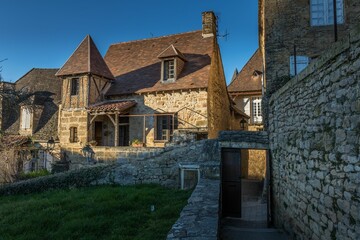 Poster - Traditional medieval house against a blue sky in Sarlat, France