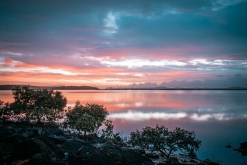 Poster - View of an Early morning sunrise shot looking over the harbor into Auckland City in the background.