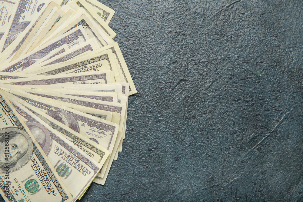 One hundred dollar banknotes on black grunge background