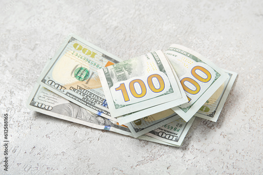 One hundred dollar banknotes on grey grunge background