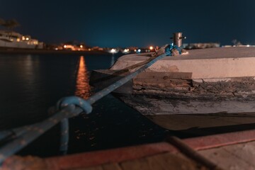 Long-time exposure of a boat in El Gouna lagoon on a view of the illuminated city at night